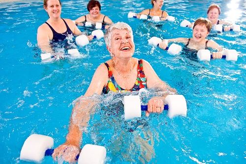 Senior participating in a water aerobics class.